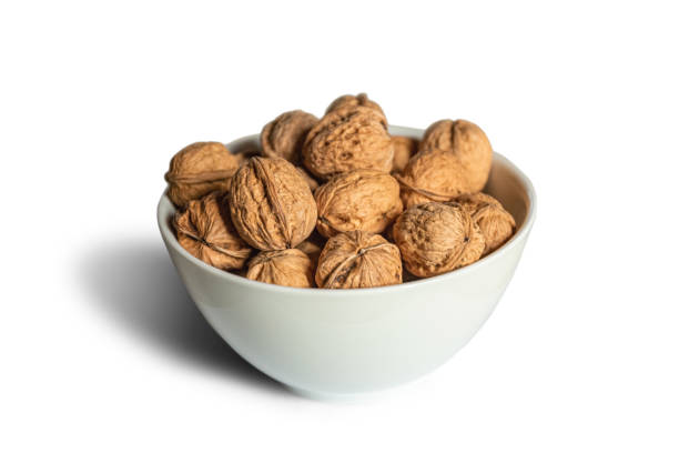 istock White bowl full of walnuts on a white background 1392785875