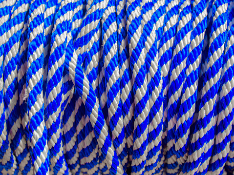 Close-up photography of a blue and white nylon rope rolled up.