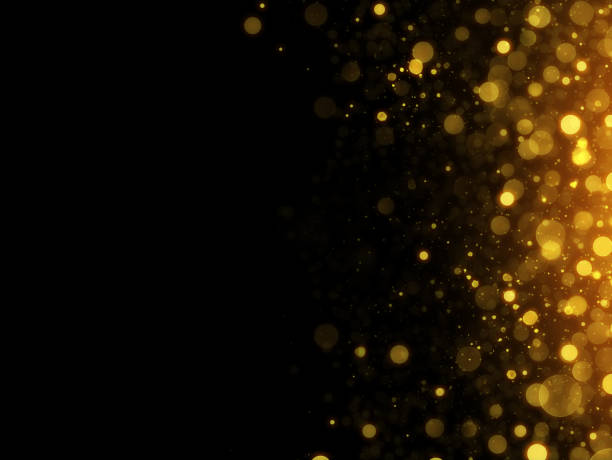 abstrakter defokussierter schwarzer hintergrund mit goldpartikeln - abstract backgrounds glowing shiny stock-grafiken, -clipart, -cartoons und -symbole