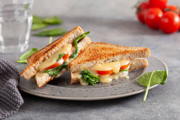istock grilled cheese spinach and tomato sandwich on concrete background 1392788906