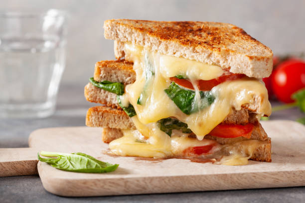 istock grilled cheese spinach and tomato sandwich on concrete background 1392788923