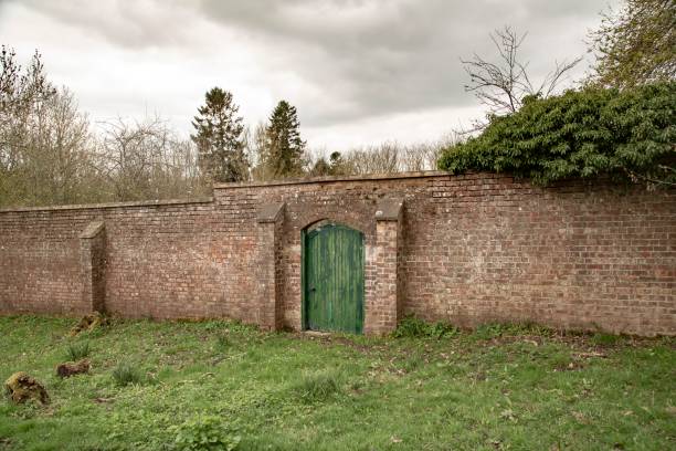 istock Green Door In Old Stone Wall. 1392789154
