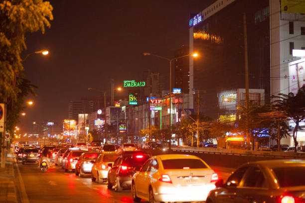 Night and evening traffic jam on Ratchadaphisek Road in Bangkok in area of Huai Khwang with many entertainment buildings at right side.