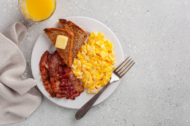 istock traditional scrambled egg breakfast with bacon and toast 1392789872
