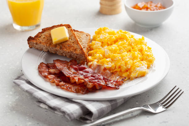 istock traditional scrambled egg breakfast with bacon and toast 1392789903