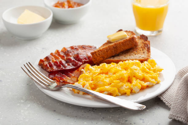 istock traditional scrambled egg breakfast with bacon and toast 1392789914