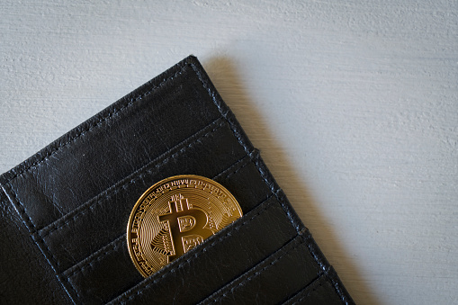 Istanbul, Turkey, January 5, 2022: Coins of bitcoin on a wallet