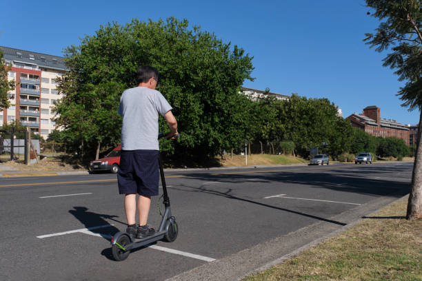 istock Hispanic senior man riding his electric kick scooter, modern transportation 1392793561