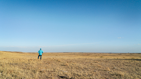 prairie in northern Colorado at early spring with a lonely male figure - Soapstone Prairie Natural Area near Fort Collins