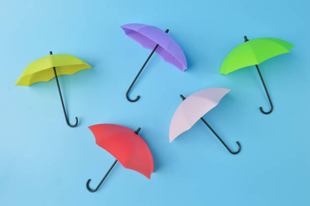 istock Colorful toy umbrella isolated on a blue background 1392795976