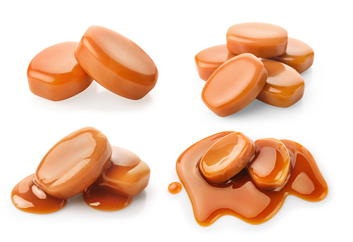 Set of golden caramel pieces and caramel sauce isolated on white background.