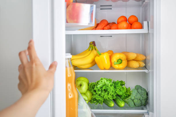 istock Open fridge full of vegetables and fruits 1392801497