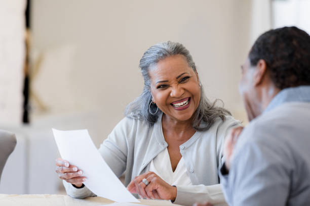 istock Senior wife smiles happily at unrecognizable husband 1392802418