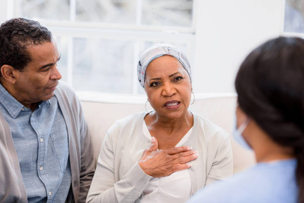 istock Husband concerned as wife describes symptom to unrecognizable nurse 1392802429