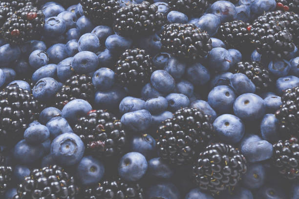 istock Blackberry and  blueberry background. Top view. 1392803784
