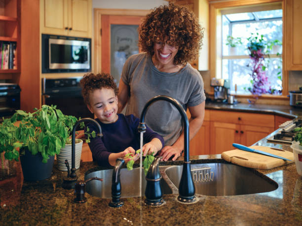 istock Mother and Son Preparing Herbs from a Garden 1392803982