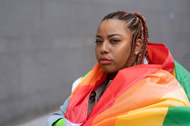 istock Confident black woman outdoors holding a rainbow flag 1392804916