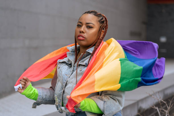 istock Confident black woman outdoors holding a rainbow flag 1392804976
