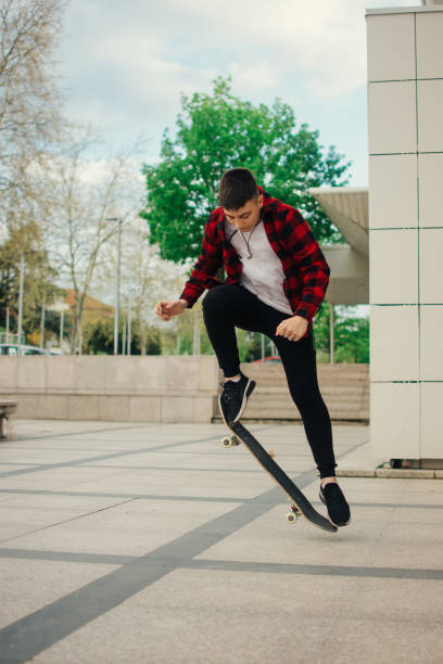istock Young skateboarder in action mid air 1392805444