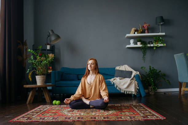 istock a woman does yoga at home 1392807462