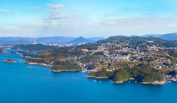 Bird's-eye view of a seascape of Sasebo called Kujkushima meaning 99 Islands famous for its saw-toothed coast with multiple islets part of Saikai National Park.