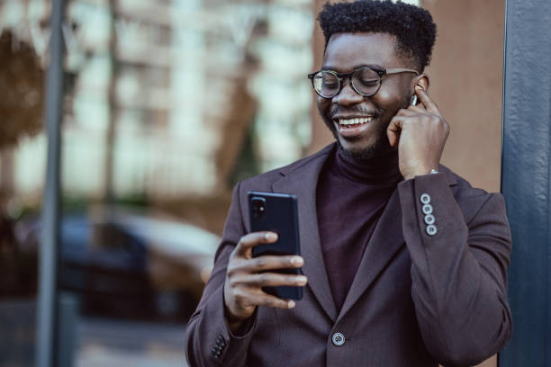 istock Good looking African-American businessmen using smartphone 1392807540