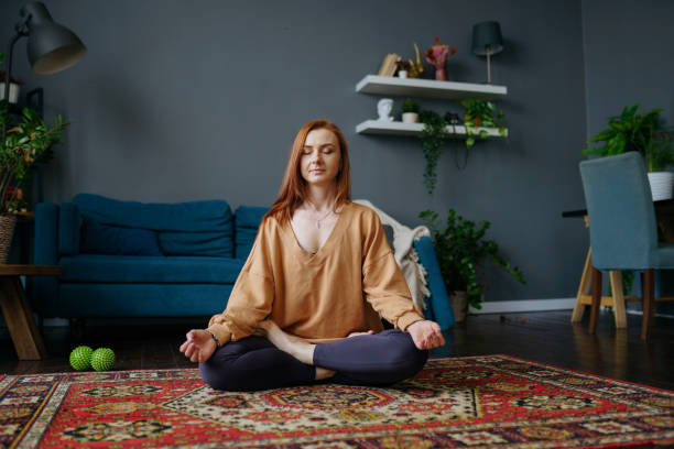 istock a woman does yoga at home 1392807601