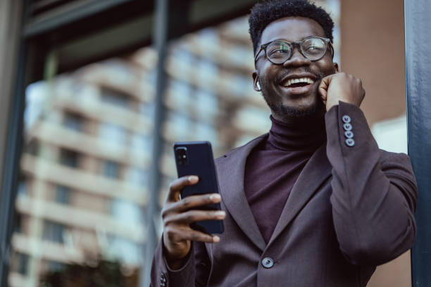 istock Good looking African-American businessmen using smartphone 1392807659