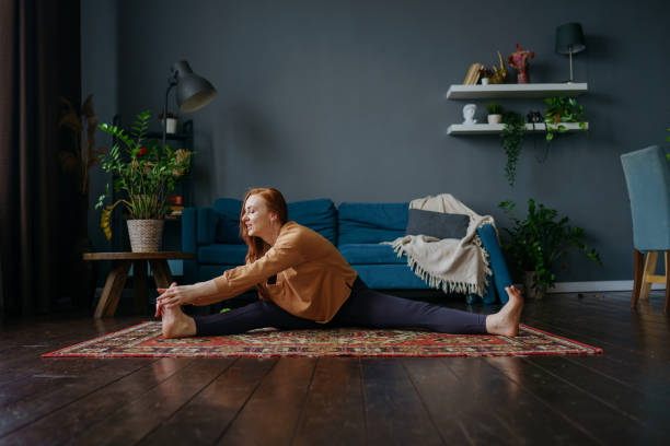istock a woman does stretching at home 1392807695