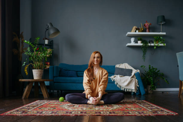 istock a woman does stretching at home 1392807698