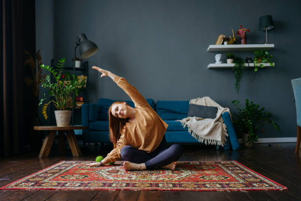istock a woman does yoga at home 1392807831