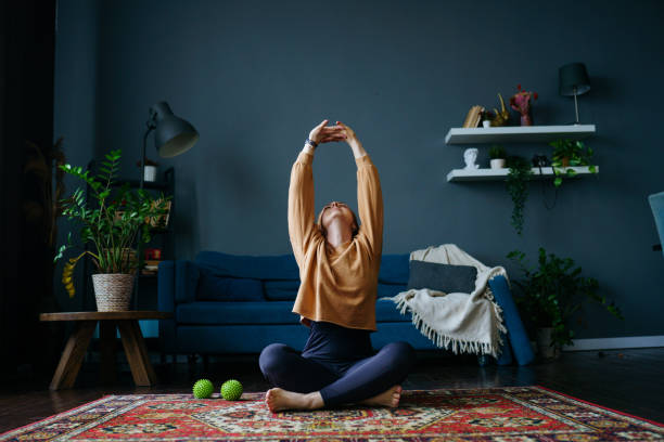 istock a woman stretches on the floor 1392807928