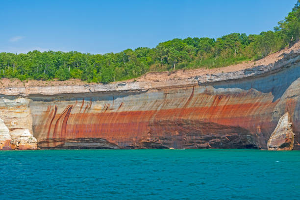 Red Cliffs Above Blue Waters stock photo