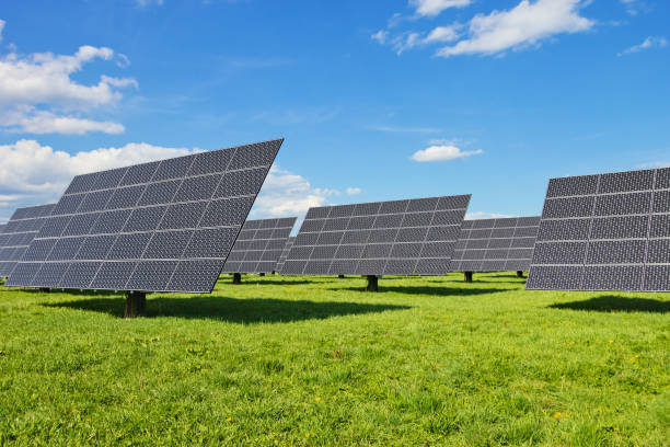 Solar power plant on green meadow stock photo