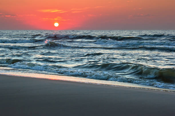 Sunset over rough seas stock photo