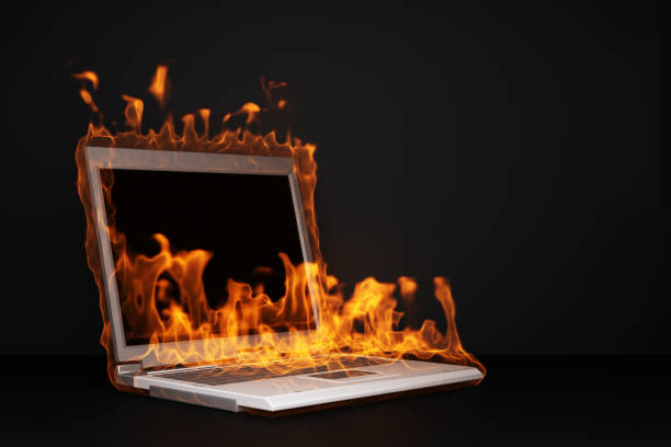 istock burning laptop on black background 1392813344