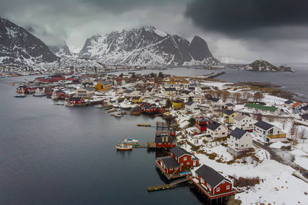 vista aerea della baia del villaggio di reine fisdherman ripresa con un drone in inverno - isole lofoten - norvegia - mountain snow sunset house foto e immagini stock