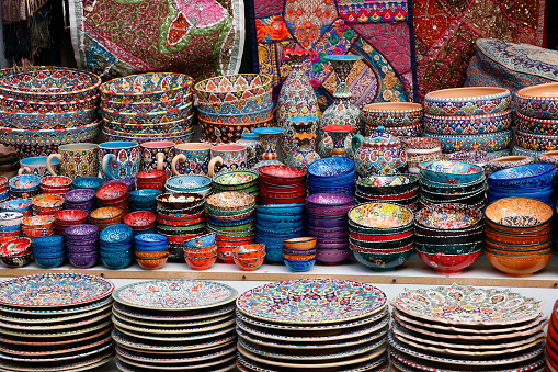 arabian style colorful ceramic plates and cutlery for sell in a street market stall