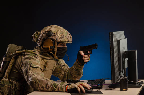 istock soldier sitting at a computer is conducting a cyber war 1392824406