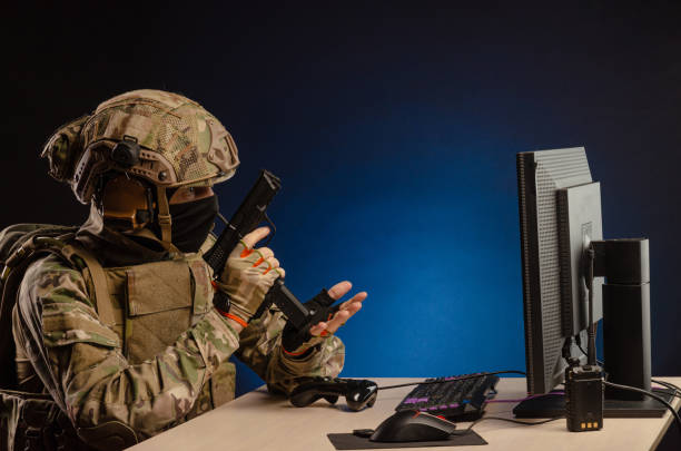 istock soldier sitting at a computer is conducting a cyber war 1392824417