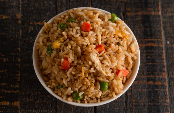 istock Bowl of Fried Rice on a Wooden Table 1392828288