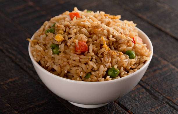 istock Bowl of Fried Rice on a Wooden Table 1392828378