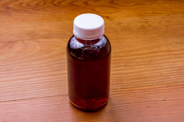 istock a bottle of red compote on wooden table side view 1392830220