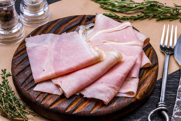 istock Prosciutto cotto sliced on a wooden board 1392830607