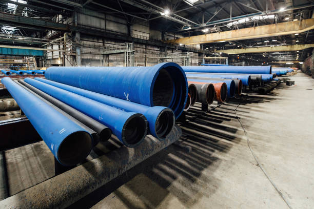 istock New cast iron pipes for pipeline construction in warehouse 1392835538