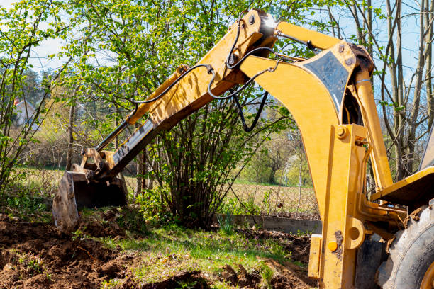 istock An excavator digging soil in a village in a private yard. 1392835669