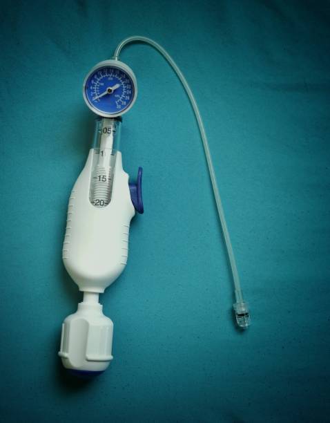 A balloon inflation device used in angioplasty procedure. A balloon inflation device used in angioplasty procedure.image on a blue background. interventional procedure stock pictures, royalty-free photos & images