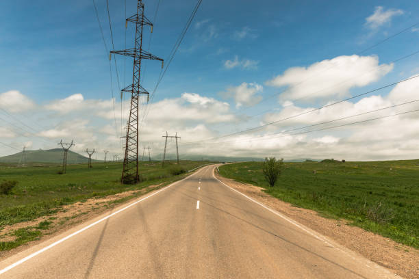 istock Electric pole tower by the road 1392836959