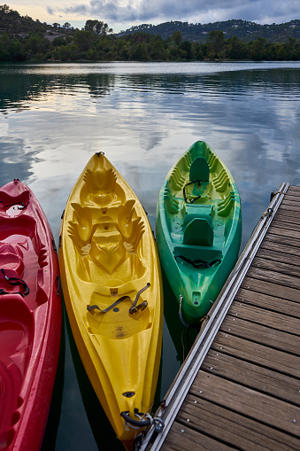 Three Kayaks at Sunset moored to a pontoon on the edge of Lac d'Esparron Provence France.