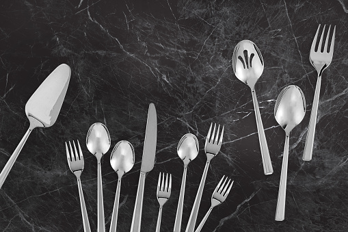 Kitchen flatware cutlery set on a black marble background